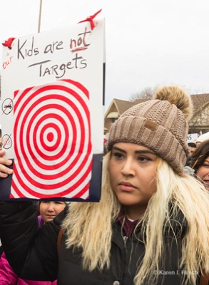 Kids are not targets sign held my woman
